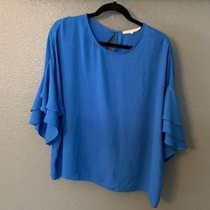 Roy’s blue polyester blouse.